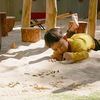 Child plays in the sand at British Early Years Centre International kindergarten in Bangok
